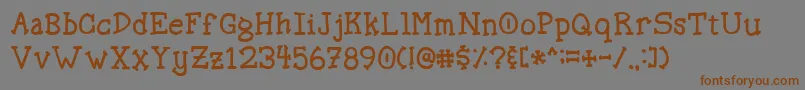 フォントSpellstone – 茶色の文字が灰色の背景にあります。