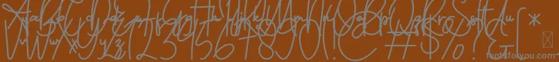 FeliciaSignature Script-fontti – harmaat kirjasimet ruskealla taustalla