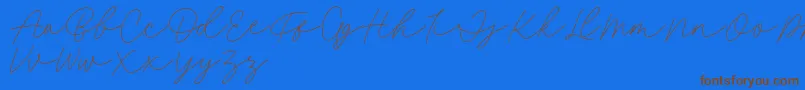 Fillia Script FREE-Schriftart – Braune Schriften auf blauem Hintergrund