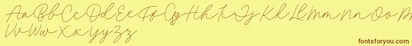 Fillia Script FREE-Schriftart – Braune Schriften auf gelbem Hintergrund