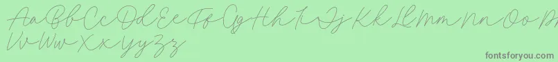 Fillia Script FREE-Schriftart – Graue Schriften auf grünem Hintergrund