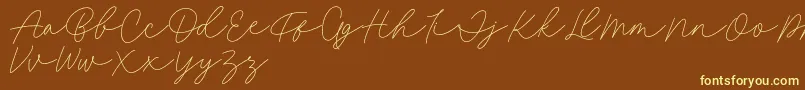 Fonte Fillia Script FREE – fontes amarelas em um fundo marrom