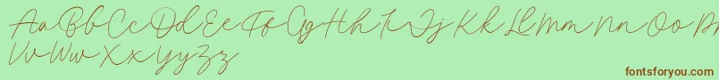 Fillia Script FREE-Schriftart – Braune Schriften auf grünem Hintergrund