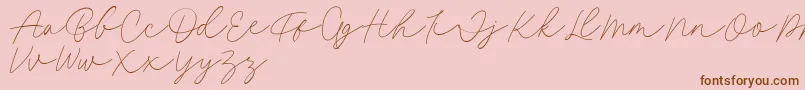 Fillia Script FREE-Schriftart – Braune Schriften auf rosa Hintergrund