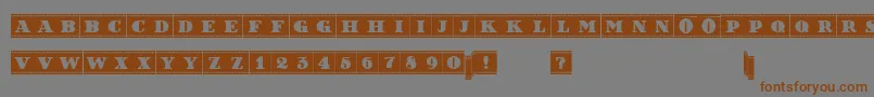 フォントFilmLettersFilled – 茶色の文字が灰色の背景にあります。