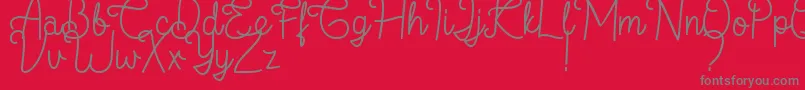 Flamingo Regular-fontti – harmaat kirjasimet punaisella taustalla