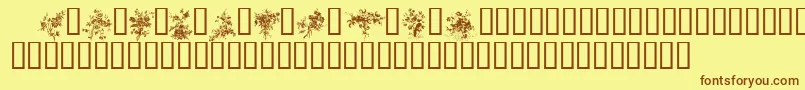 フォントFLORALS1 – 茶色の文字が黄色の背景にあります。