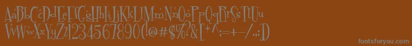 Fonte FontdinerdotcomSparkly – fontes cinzas em um fundo marrom