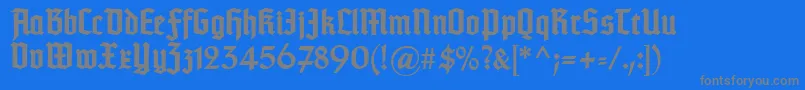 TypographertexturBold-fontti – harmaat kirjasimet sinisellä taustalla