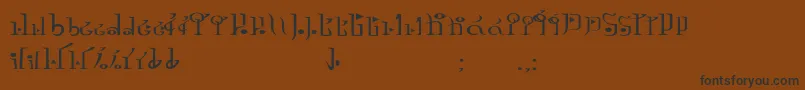 フォントTphylianGcnregular – 黒い文字が茶色の背景にあります