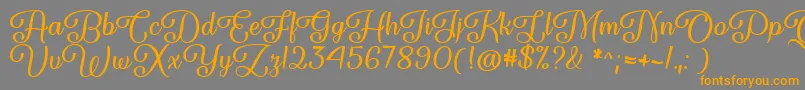 フォントForgiven Script   – オレンジの文字は灰色の背景にあります。