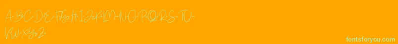 Free Yuminika Script-Schriftart – Grüne Schriften auf orangefarbenem Hintergrund