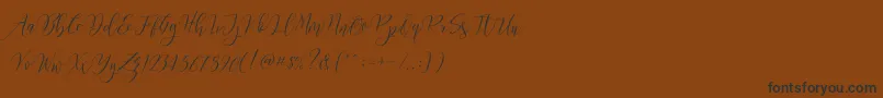 フォントFrutilla Script – 黒い文字が茶色の背景にあります