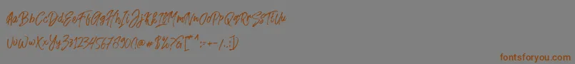 フォントFusterd Brush – 茶色の文字が灰色の背景にあります。