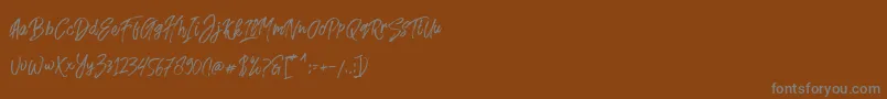 Fusterd Brush-Schriftart – Graue Schriften auf braunem Hintergrund
