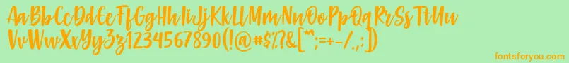 Gabelisa Font by Keithzo 7NTypes Font – Orange Fonts on Green Background