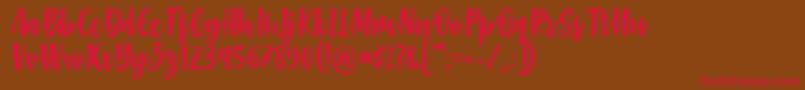 フォントGabelisa Font by Keithzo 7NTypes – 赤い文字が茶色の背景にあります。