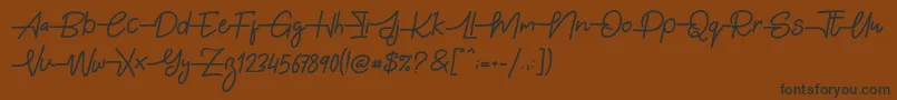 Gabuek Script Font – Black Fonts on Brown Background