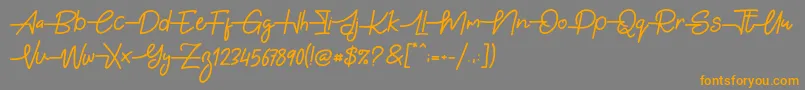 Gabuek Script Font – Orange Fonts on Gray Background