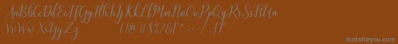 フォントgalatia – 茶色の背景に灰色の文字