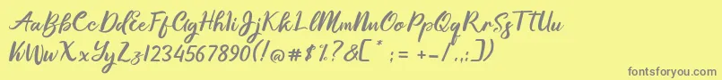 Fonte Gallisia Design Script – fontes cinzas em um fundo amarelo