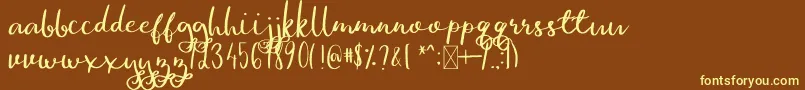 GinaAnn-fontti – keltaiset fontit ruskealla taustalla