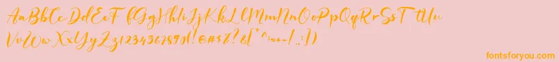 フォントGISELLE – オレンジの文字がピンクの背景にあります。