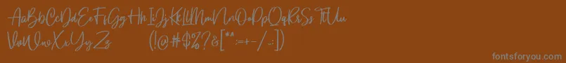 Gloryouss Demo-Schriftart – Graue Schriften auf braunem Hintergrund