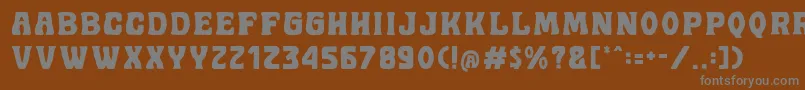 Golddrew DEMO-fontti – harmaat kirjasimet ruskealla taustalla