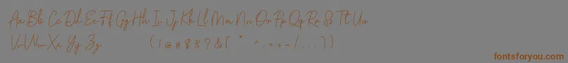 フォントGolden Bridge Script – 茶色の文字が灰色の背景にあります。