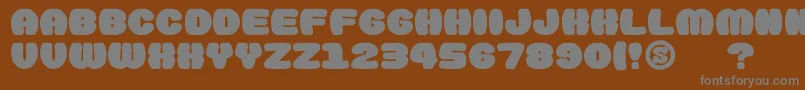 gomarice doughnut monster-fontti – harmaat kirjasimet ruskealla taustalla