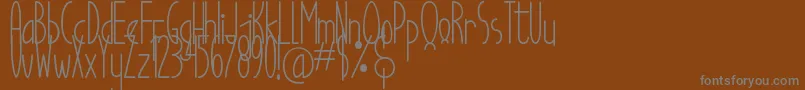 Good Egg Dafont-Schriftart – Graue Schriften auf braunem Hintergrund