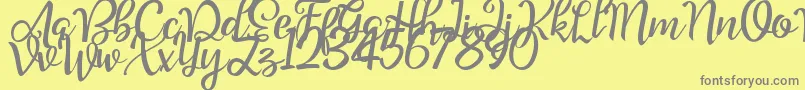 Good Feeling Script Demo-fontti – harmaat kirjasimet keltaisella taustalla