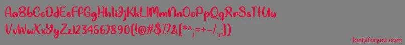 Good Unicorn  -Schriftart – Rote Schriften auf grauem Hintergrund