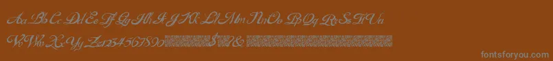 GouldenTreatise-Schriftart – Graue Schriften auf braunem Hintergrund