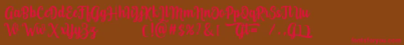 フォントGrafiteg free – 赤い文字が茶色の背景にあります。