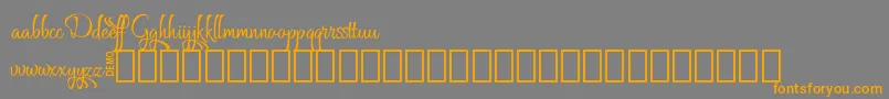 フォントGrafyk Demo – オレンジの文字は灰色の背景にあります。