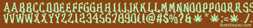 フォントGRASS – 緑色の文字が茶色の背景にあります。