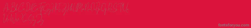 Fonte Gravity Handwritten – fontes cinzas em um fundo vermelho