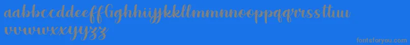 Grestal Script Demo-Schriftart – Graue Schriften auf blauem Hintergrund