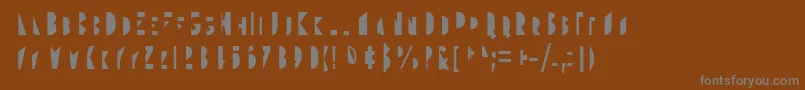 Gudariak Txano-fontti – harmaat kirjasimet ruskealla taustalla