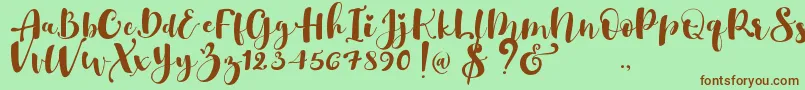 Fonte Gulya Script   – fontes marrons em um fundo verde