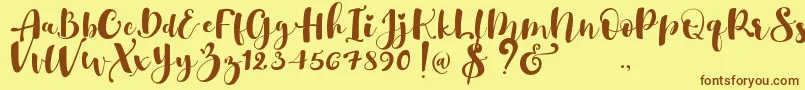 Gulya Script  -Schriftart – Braune Schriften auf gelbem Hintergrund