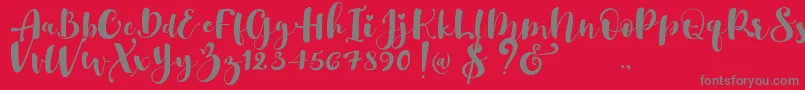 Gulya Script  -Schriftart – Graue Schriften auf rotem Hintergrund
