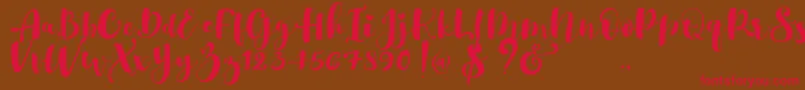 Gulya Script  -Schriftart – Rote Schriften auf braunem Hintergrund