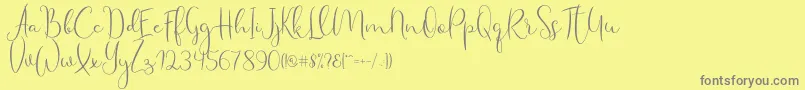 Fonte Haertbel Script – fontes cinzas em um fundo amarelo