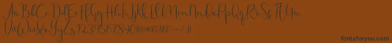 Haertbel Script Font – Black Fonts on Brown Background