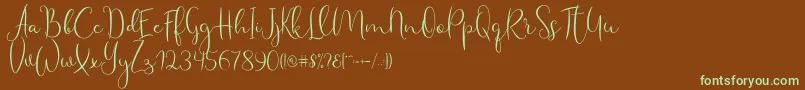 フォントHaertbel Script – 緑色の文字が茶色の背景にあります。