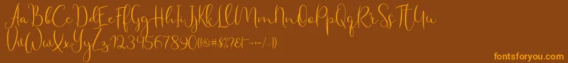 Haertbel Script-Schriftart – Orangefarbene Schriften auf braunem Hintergrund