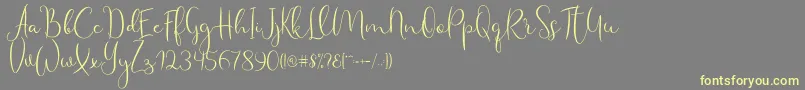 Haertbel Script Font – Yellow Fonts on Gray Background